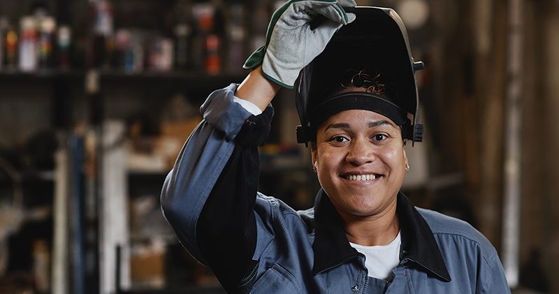 Woman Welding Metal In Workshop